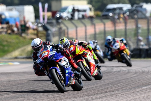 Kam battles with Isle of Man TT specialist Nathan Harrison (15).